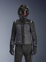 Alpinestars Cusco Drystar® Jacket, Black and Deep Gray, motorcycle adventure touring jacket worn with matching black technical pants and a dual-sport helmet, featuring a two-tone design with ripstop panels and Alpinestars branding