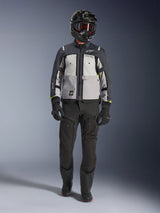 Alpinestars Cusco Drystar® Jacket, Ice Gray Mid Gray Deep Gray, adventure motorcycle jacket worn with black riding pants, black gloves, and a black helmet with goggles, featuring color-blocked gray panels and technical detailing for road and adventure touring.