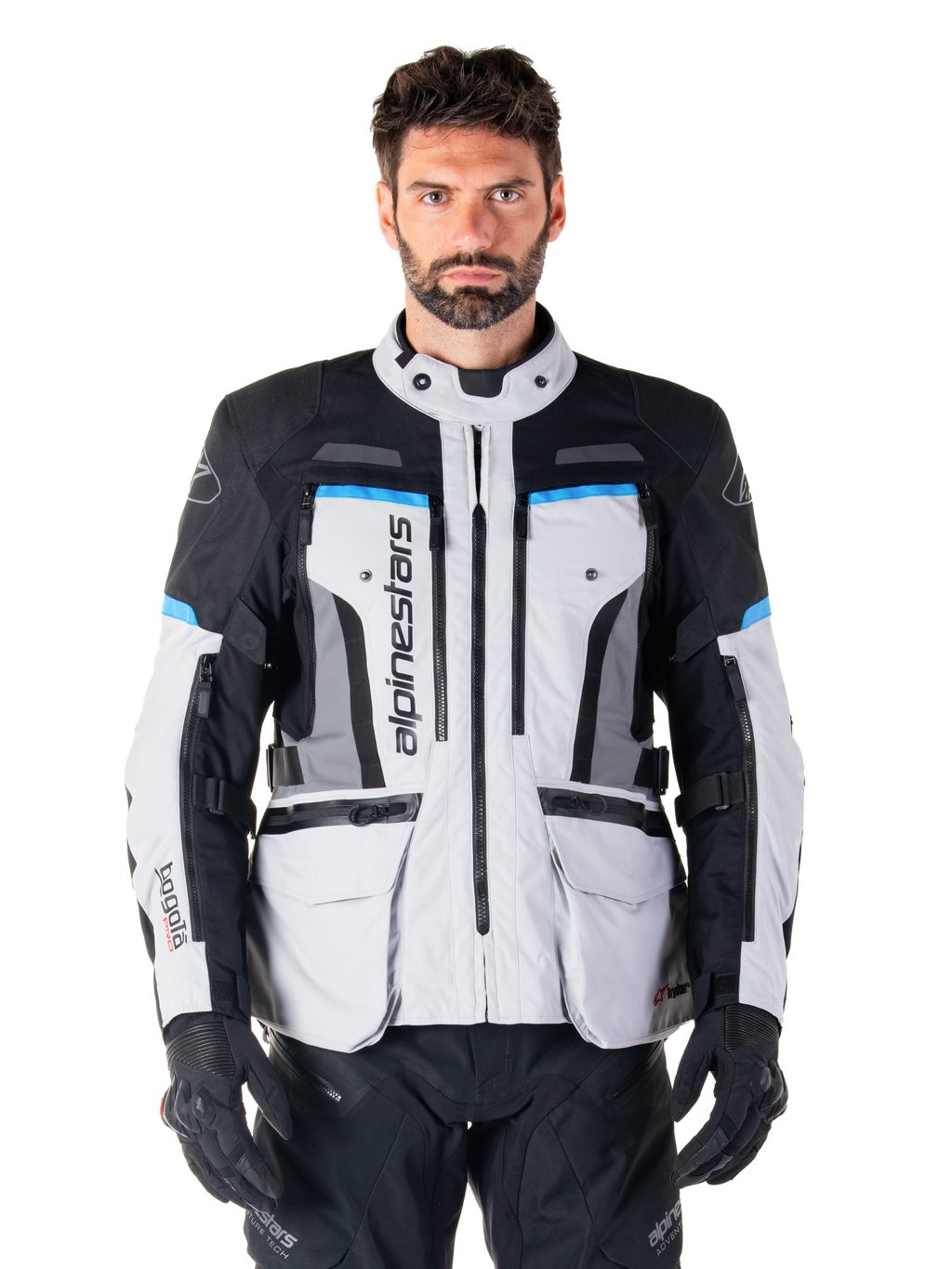 Alpinestars Bogota Pro Drystar Jacket, Motorcycle Adventure Touring Jacket, Ice Gray with Black and Cyan blue accents, front view showing ventilation panels and cargo pockets, worn by a model with black riding pants and gloves
