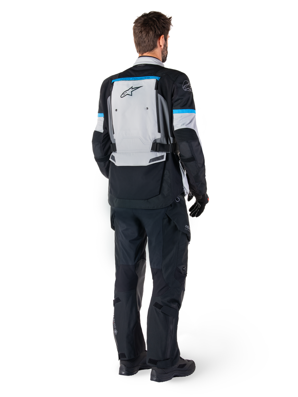 Alpinestars Bogota' Pro Drystar® Jacket, Adventure Motorcycle Jacket, Ice Gray Black and Cyan, rear view worn with matching black pants and gloves, featuring a large gray back panel with black Alpinestars logo and cyan blue accents.