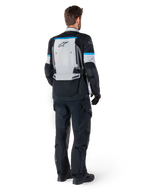 Alpinestars Bogota' Pro Drystar® Jacket, Adventure Motorcycle Jacket, Ice Gray Black and Cyan, rear view worn with matching black pants and gloves, featuring a large gray back panel with black Alpinestars logo and cyan blue accents.