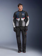 Alpinestars Andes Air Drystar® Jacket, Motorcycle Touring Jacket, Deep Blue Black and Ice Gray, worn with matching black adventure pants and gloves, featuring mesh panels for airflow and a technical multi-pocket design.