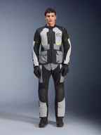 Alpinestars Andes Air Drystar® Pants, Adventure Touring Motorcycle Pants, Ice Gray and Black with neon yellow accents, full-body view on a model wearing the matching jacket and gloves, textile design with mesh ventilation panels