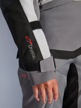 Alpinestars Stella Andes V4 Drystar® Jacket, women's gray textile adventure sleeve with logo and velcro wrist closure.