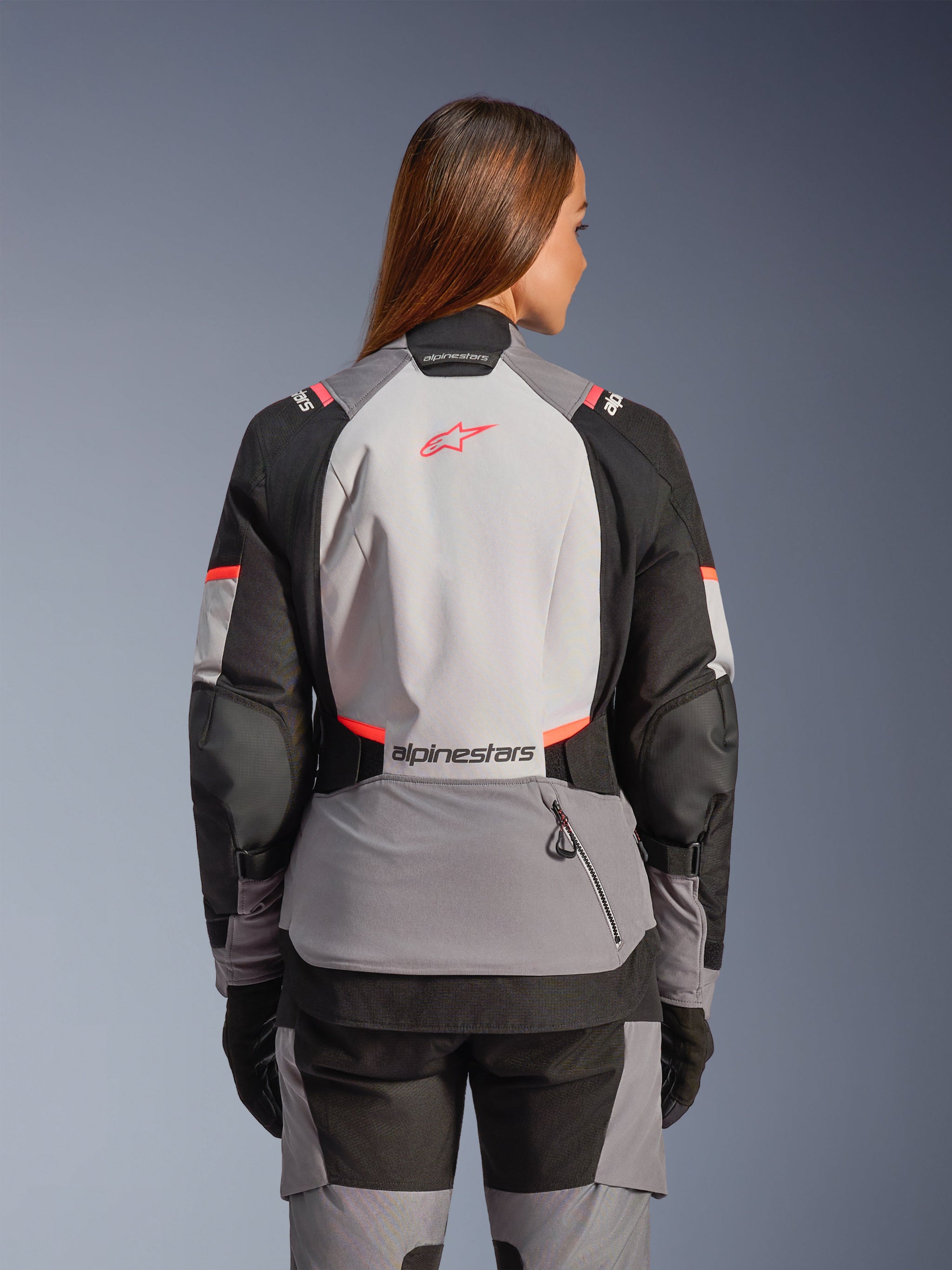 Alpinestars Stella Andes V4 Drystar® Jacket, a women's adventure motorcycle jacket in gray and coral, rear view.