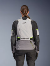 Alpinestars Stella Andes V4 Drystar® Jacket, Woman's Adventure Motorcycle Jacket, back view, Ice Gray, Dark Gray, and Black with Yellow Fluo accents, featuring Alpinestars branding on upper and lower back, durable textile construction for all-weather touring