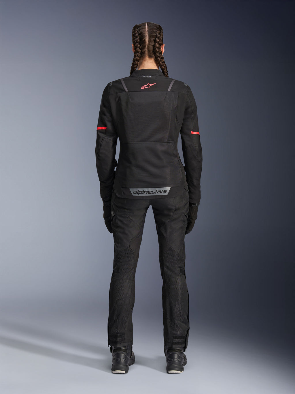 Alpinestars Stella Andes Air Drystar® Pants, Women's Motorcycle Pants, Black, rear view worn with a matching mesh jacket featuring red accents, highlighting mesh ventilation panels and reflective branding on the lower back, designed for adventure and road touring.