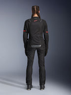 Alpinestars Stella Andes Air Drystar® Pants, Women's Motorcycle Pants, Black, rear view worn with a matching mesh jacket featuring red accents, highlighting mesh ventilation panels and reflective branding on the lower back, designed for adventure and road touring.
