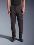 Alpinestars Aeroshell Pants, Black softshell motorcycle pants, jogger-style athletic fit with drawstring waist and elastic cuffs, featuring a white Astars logo, worn with black riding shoes, modern crossover gear for road and casual use