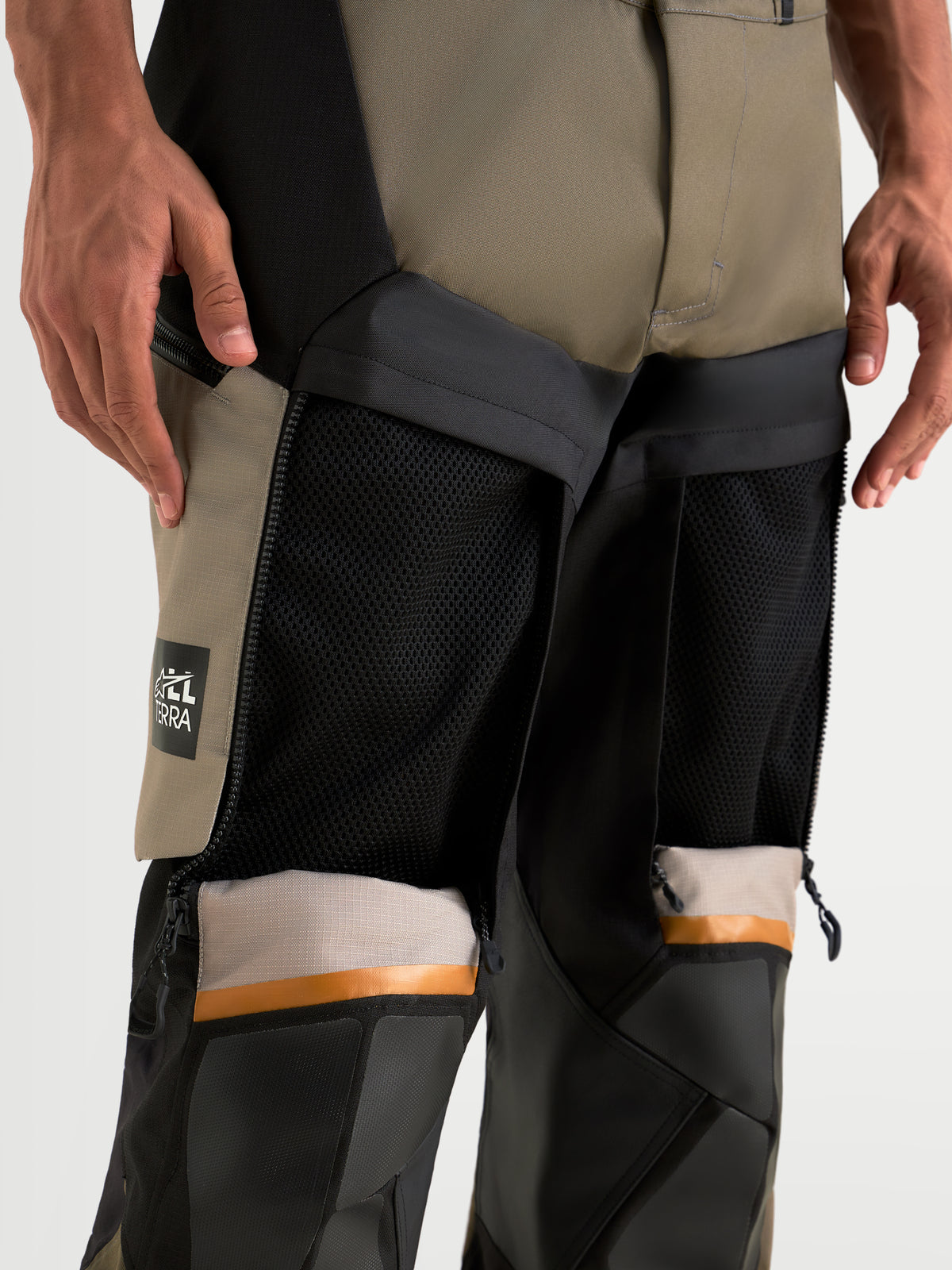 Alpinestars Harok V2 Drystar Pants, men's adventure touring motorcycle pants in aluminum, walnut, and black, close-up view showing open direct ventilation thigh panels and ripstop textile construction worn on a model