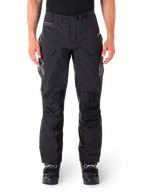 Alpinestars Hyde XT Drystar Pants, Black Adventure Touring Pants, worn by a rider with black boots, featuring grey logos on the thighs, integrated belt, reinforced knee panels, and waterproof textile construction.