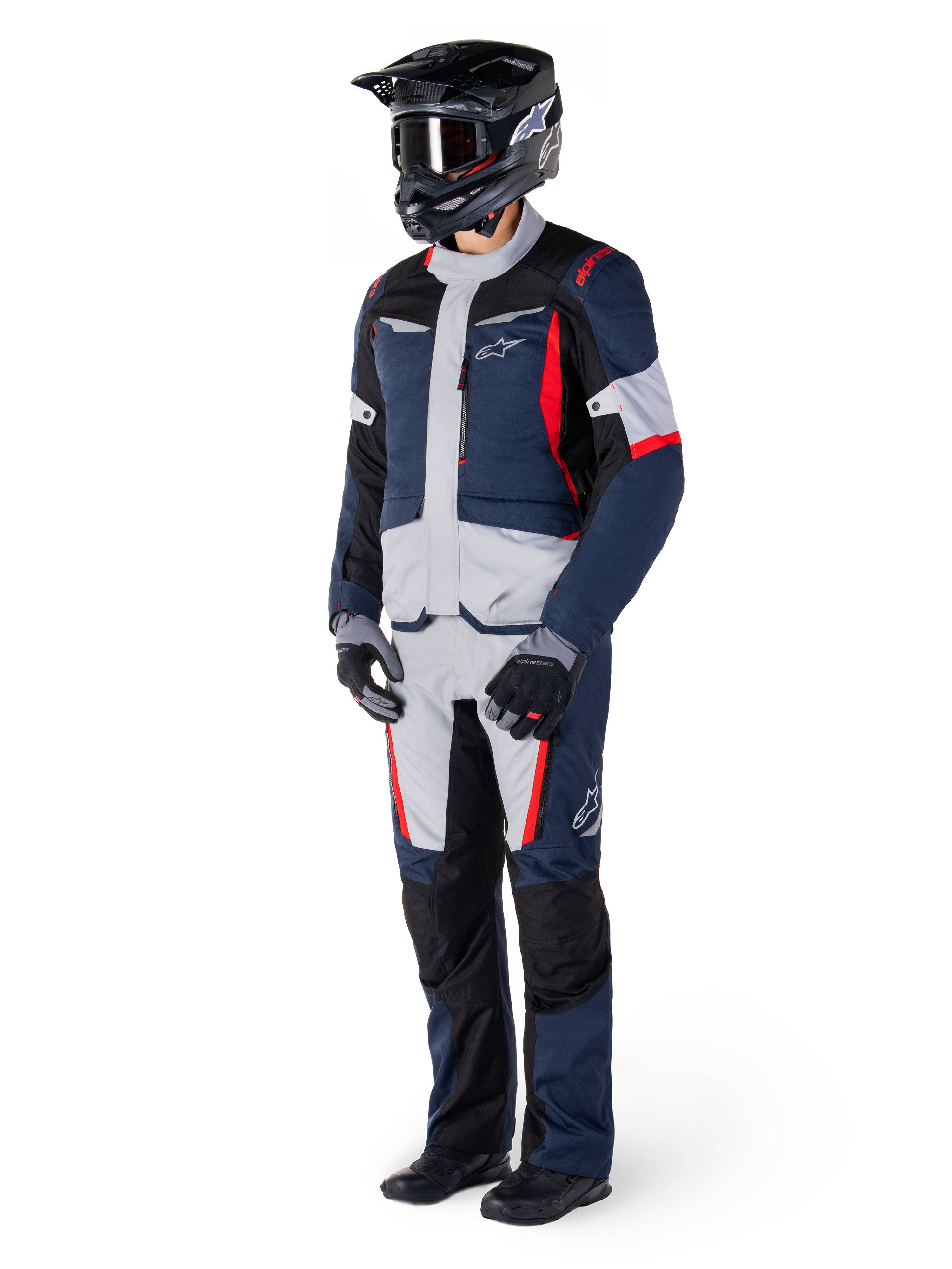 Alpinestars St-1 Waterproof Pants, Adventure Touring Pants, Dark Blue, Black, and Bright Red, worn with a matching touring jacket, black helmet, gloves, and boots, featuring light grey panels, red accents, and Alpinestars branding, designed for all-weather riding.