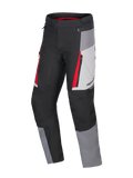 Alpinestars Honda ST-1 Waterproof Pants, Motorcycle Touring Pants, Ice Gray, Dark Gray and Black with Red Accents, technical textile construction with waterproof liner, zippered cargo pockets, and ergonomic pre-curved legs