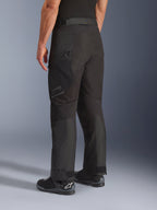 Alpinestars Cusco Drystar® Pants, Motorcycle Pants, Black, rear three-quarter view showing zippered thigh pocket and articulated panels, worn with black motorcycle boots, durable adventure touring design with subtle branding
