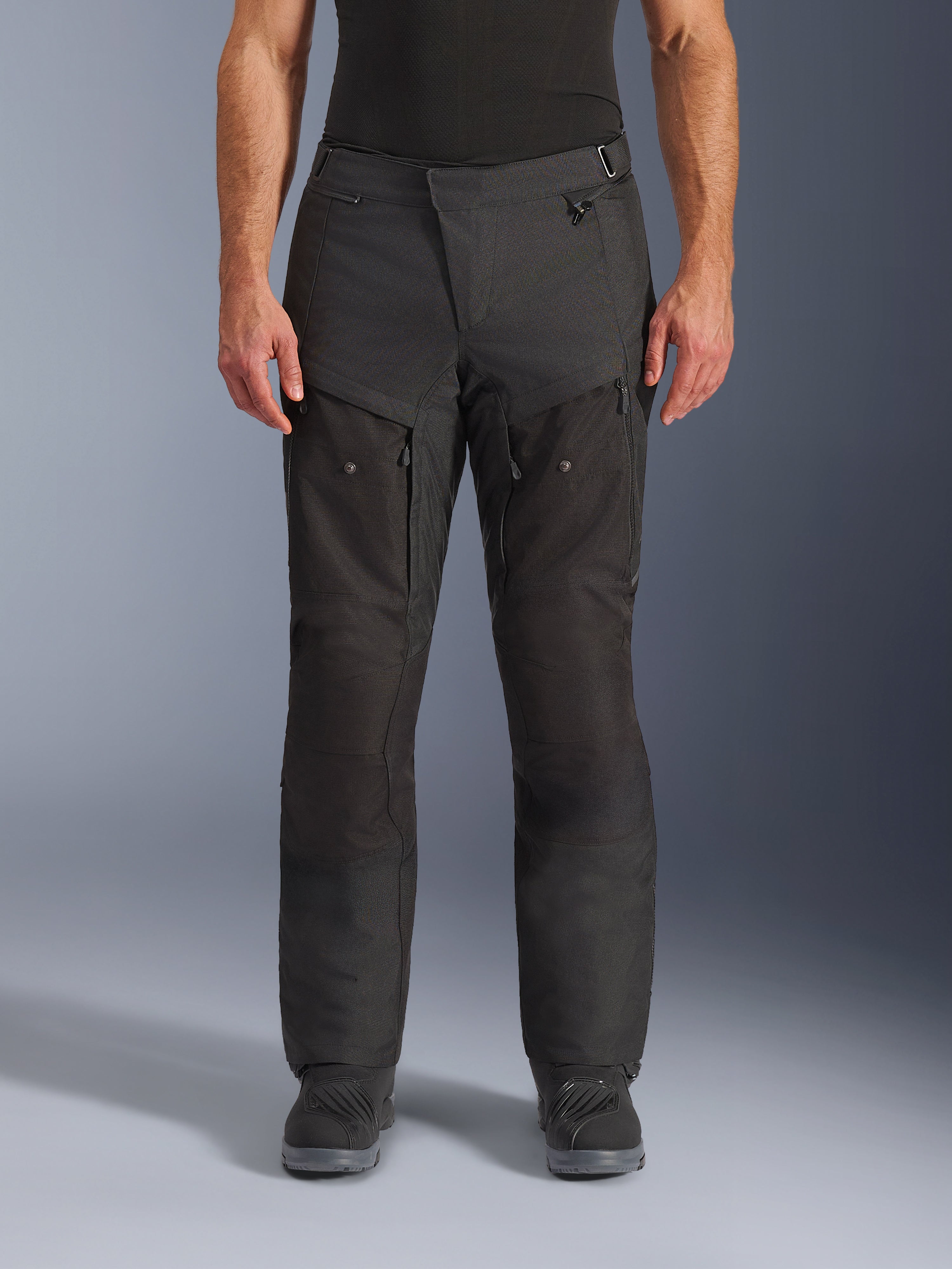 Alpinestars Cusco Drystar® Pants, Adventure Motorcycle Pants, Black, front view, featuring zippered thigh ventilation and adjustable waist, durable ripstop and 600D textile construction, worn with black boots