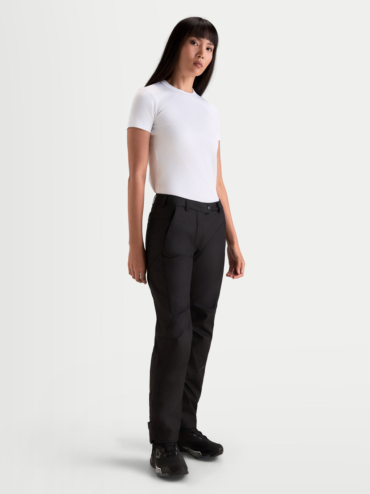 Alpinestars Stella C-1 Waterproof Pants, women's urban contemporary motorcycle pants in black, straight-leg textile construction worn by a model with a white t-shirt, cold-season riding apparel