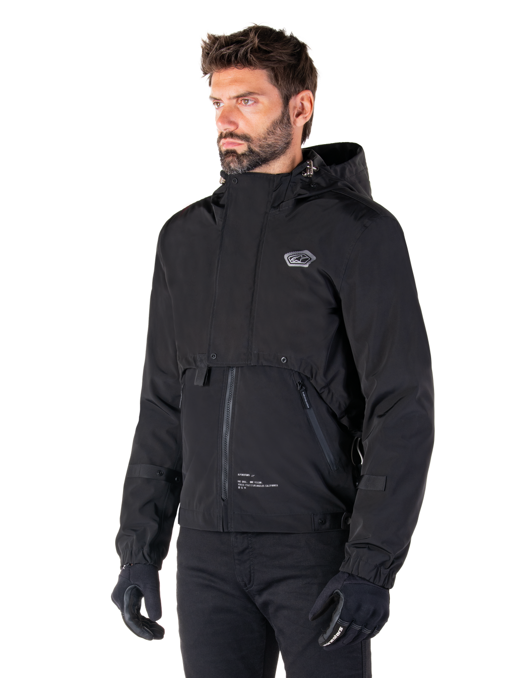 Alpinestars Mootant Waterproof Parka, Black modular motorcycle jacket, worn by a man with black gloves and pants, features a hood, front zipper, and layered utilitarian design, sleek urban aesthetic with logo on chest.