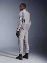 Alpinestars Aeroshell Airflow Jacket in Mid Gray Anthracite, worn with matching pants and black racing gloves, back view showing laser-perforated panels and athletic sport fit, professional motorcycle apparel