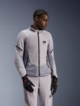 Alpinestars Aeroshell Airflow Jacket, Mid Gray Anthracite, worn by a model with matching textile pants and black gloves with red accents, featuring laser-perforated zones and mesh panels for ventilation, sleek sport-fit design for motorcycle riding.