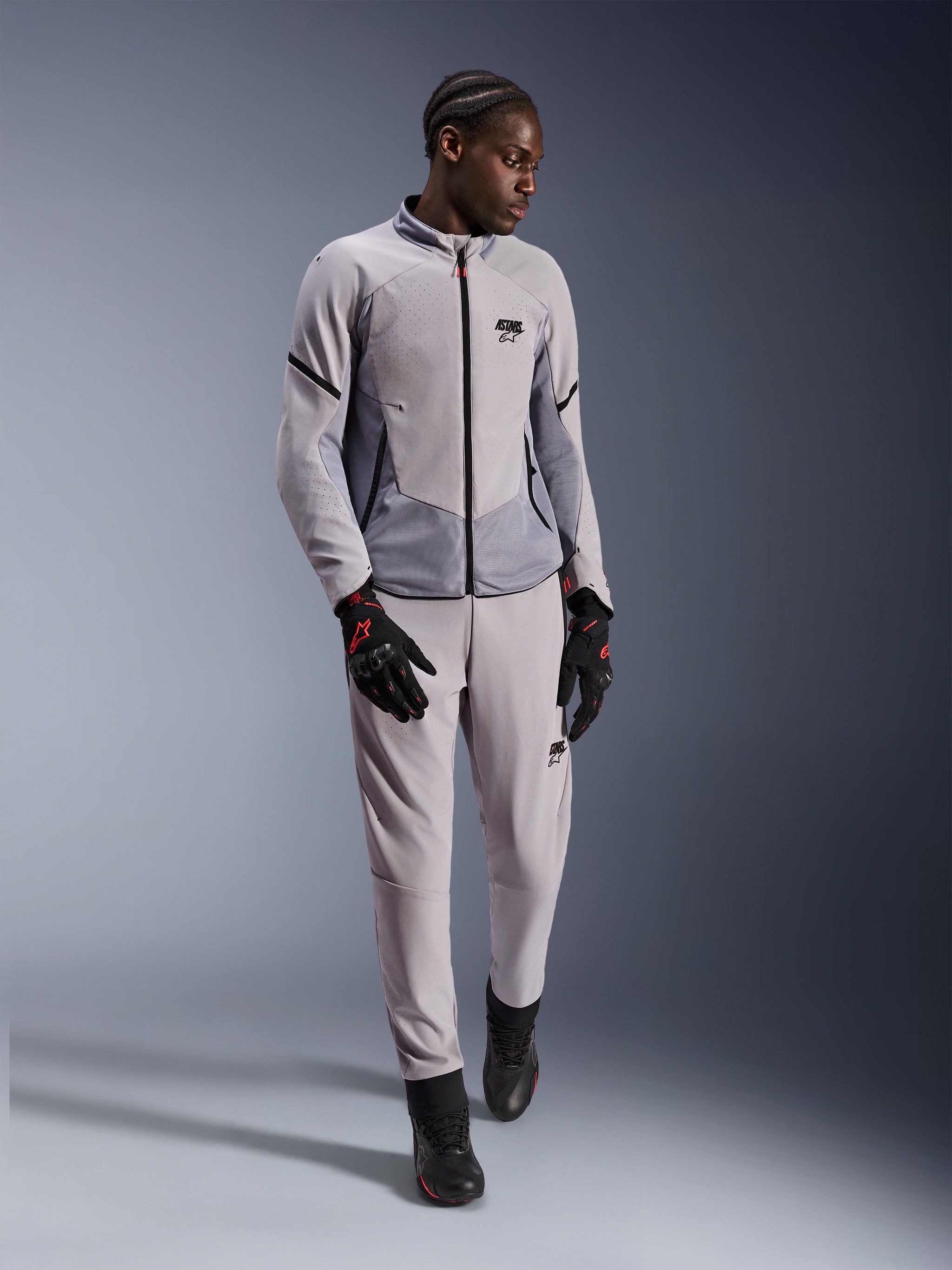 Alpinestars Aeroshell Airflow Jacket, Mid Gray Anthracite, textile motorcycle jacket with laser perforations and mesh panels, worn with matching pants and black riding accessories, lightweight and sporty design for warm-weather performance