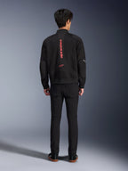 Alpinestars Flight Air Jacket in Black Bright Red, Rear view of urban bomber-style motorcycle jacket, featuring vertical red Alpinestars branding and logo on the spine, lightweight 3D mesh construction, worn with black pants for a contemporary look.