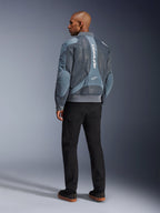 Alpinestars Flight Air Jacket, Storm Gray motorcycle jacket, back view, featuring 3D mesh ventilation panels and vertical white Alpinestars branding, worn with black pants and black sneakers, urban commuter style