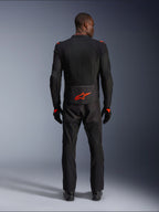 Alpinestars Viper Air V4 Jacket, Black and Red Fluo, rear view on model, worn with matching black riding pants and gloves, featuring a bright fluorescent red logo on the lower back, mesh construction for airflow, athletic fit for motorcycle road riding