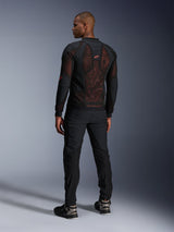 Alpinestars Troop-Air Pro Jacket in Black Red Fluo, rear view on a model, featuring a large 2D tech mesh back panel with visible red interior, paired with black technical riding pants and black/grey boots, modern urban armored motorcycle jacket design.