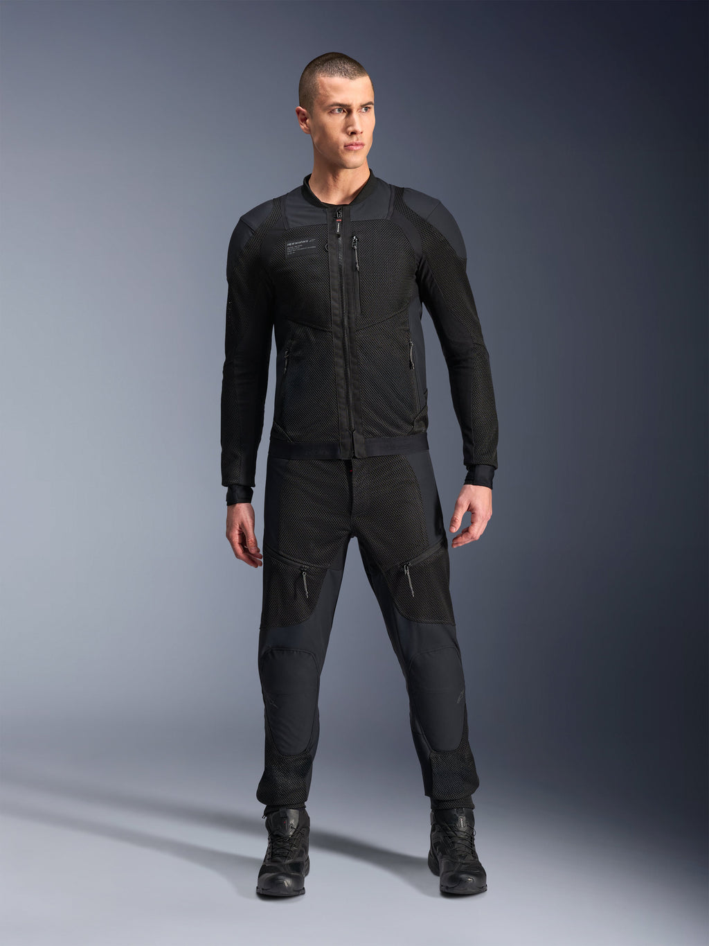 Alpinestars Troop-Air Pro Jacket, Black technical armored motorcycle jacket, featuring mesh panels and front zippers, worn with matching black pants and riding boots, premium urban road gear