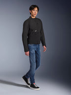 Alpinestars Provoke Jacket, Urban Motorcycle Jacket, Black, worn by a male model with blue jeans and black sneakers, technical textile design with small Alpinestars logo, full-body lifestyle shot for contemporary city riding