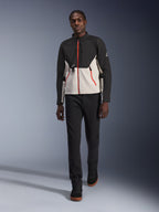 Male model wearing the Alpinestars Provoke Jacket, urban motorcycle jacket in black and metal gray with red zipper accents, paired with black pants and black high-top shoes, modern street-ready protective gear for city riding