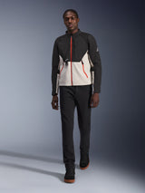 Male model wearing the Alpinestars Provoke Jacket, urban motorcycle jacket in black and metal gray with red zipper accents, paired with black pants and black high-top shoes, modern street-ready protective gear for city riding