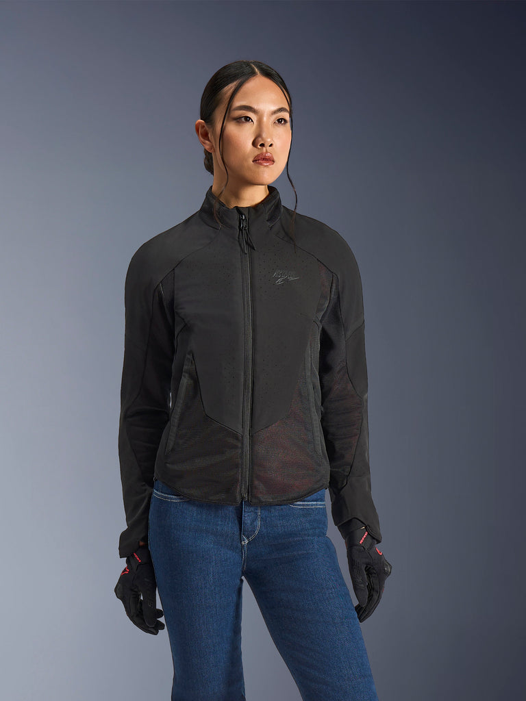 Alpinestars Stella Aeroshell Airflow Jacket, Women's Motorcycle Jacket, Black Anthracite, worn by model with blue jeans and black gloves, featuring laser-perforated softshell and mesh panels for high-flow ventilation, ergonomic sport-riding design.
