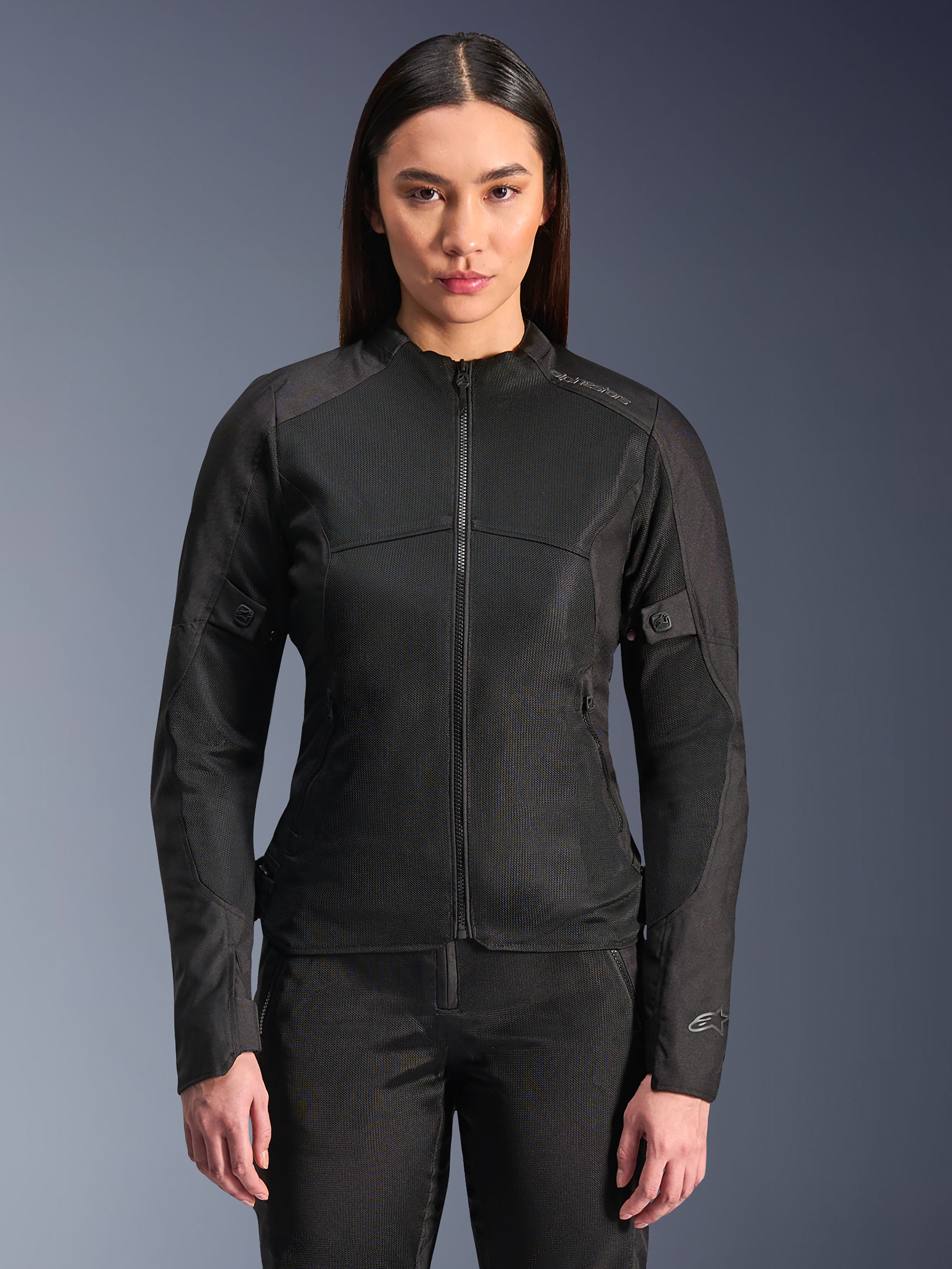 Alpinestars Stella C-1 Air Jacket, Women's Motorcycle Jacket, Black, model wearing a sleek zipped jacket with tech mesh panels, slim fit design with subtle reflective logos on the shoulder and sleeve cuff