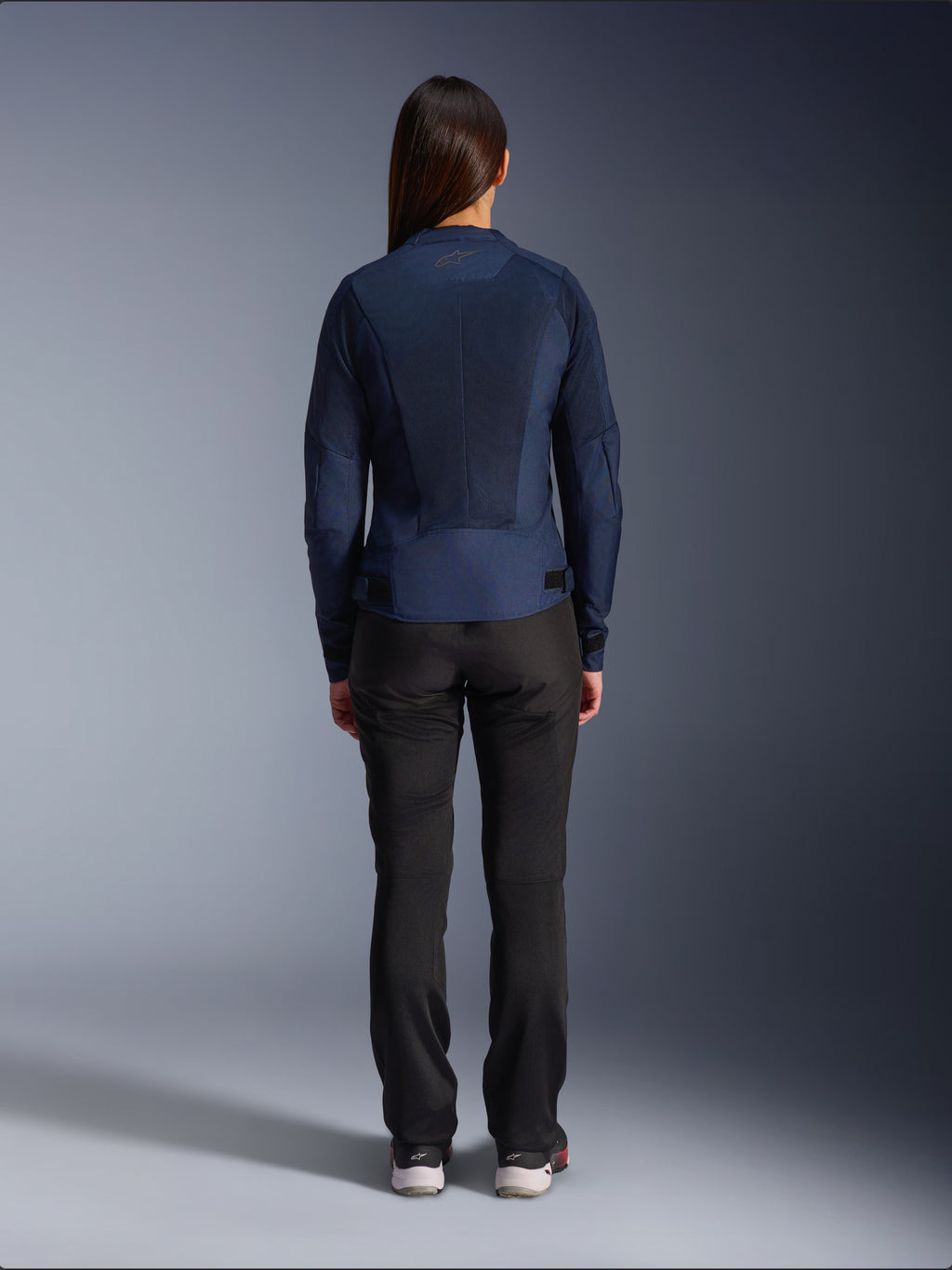 Alpinestars Stella C-1 Air Jacket, Women's Textile Motorcycle Jacket, Navy Blue, rear view featuring extensive mesh panels for ventilation and Alpinestars logo on the neck, paired with black riding pants for a modern urban look