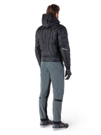 Alpinestars Alden Pants, urban motorcycle pants, Urban Gray, rear view of rider wearing a black quilted hooded jacket and riding sneakers, features slim fit below the knee with black stretch panels and knee adjusters, modern streetwear-inspired design.