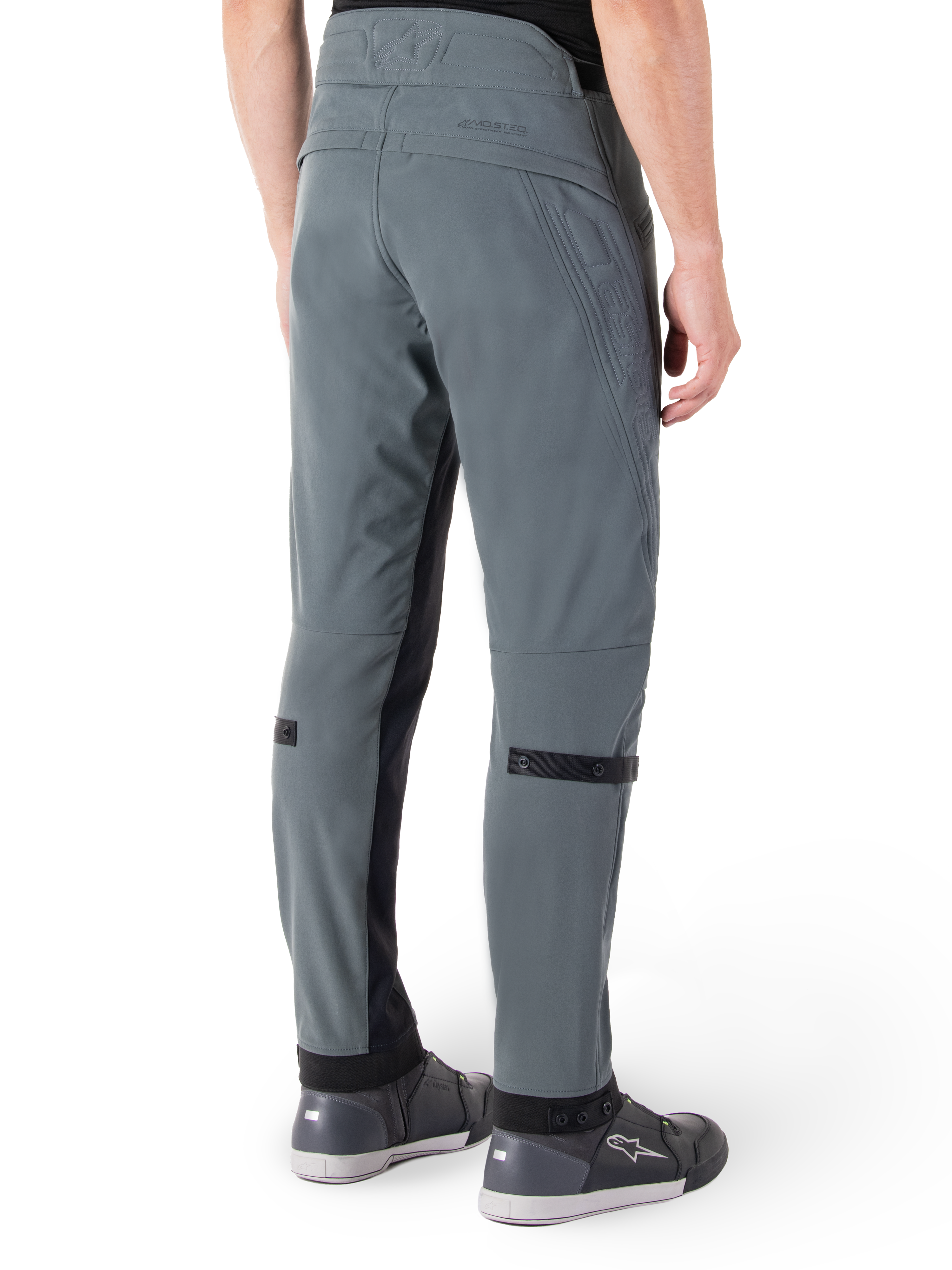 Alpinestars Alden Pants, Urban Gray, rear side view, streetwear-inspired technical riding pants with quilted detailing on the waist and black calf straps, paired with gray riding shoes, modern urban motorcycle gear