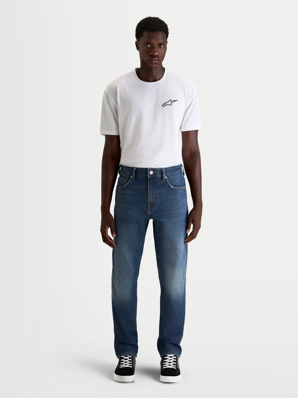 Alpinestars Flex-AST 8 Denim Pants, men's urban motorcycle riding jeans in medium blue, straight-fit single-layer technical denim worn by a model with a white t-shirt, AA certified protection.