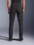 Alpinestars Flex-AST Canvas Pants, Urban Motorcycle Pants, Black, back view showing rear pockets with embroidered logo, extended back rise, and ergonomic leg seams, worn with casual black footwear