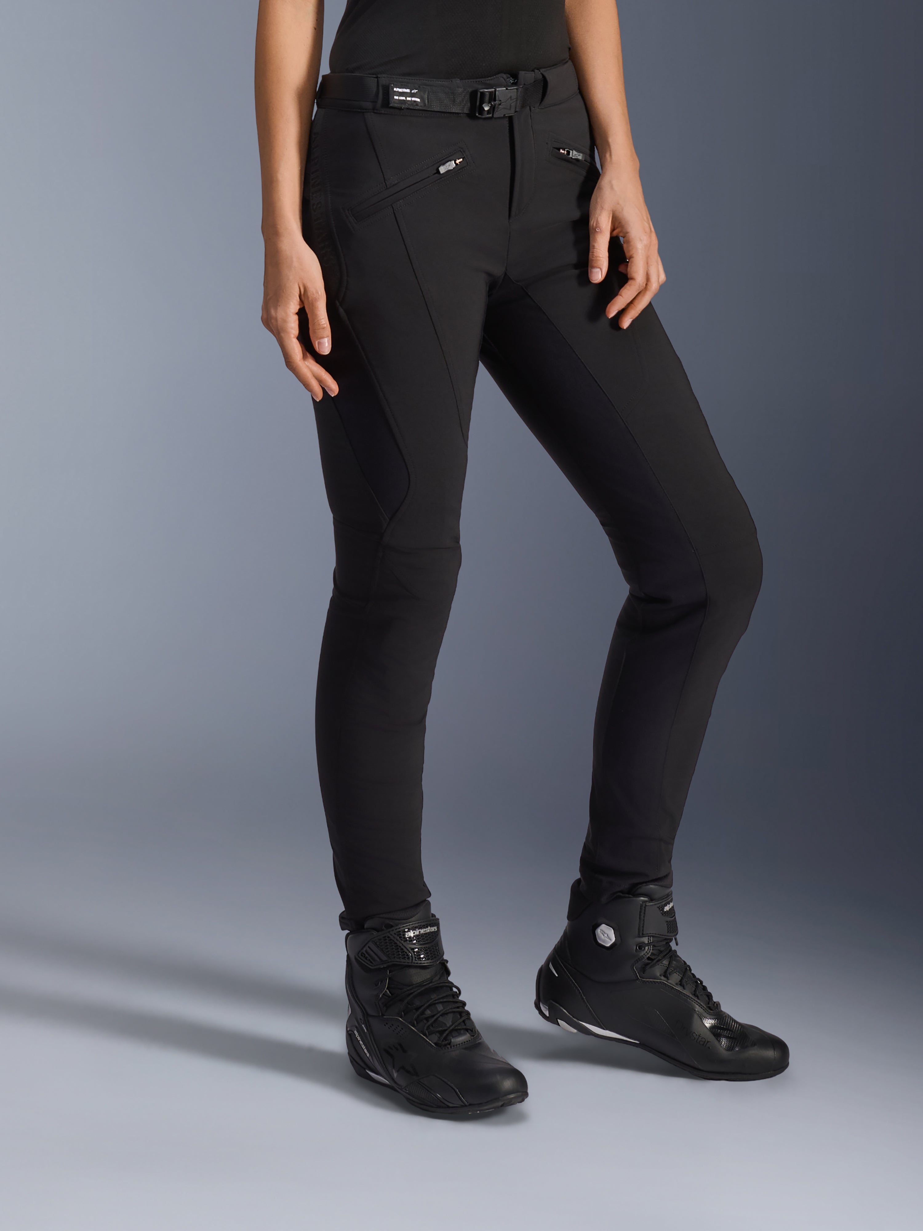 Alpinestars Alamosa Women Pants, Black Urban Motorcycle Pants, slim-fit design with zippered pockets and integrated waist belt, paired with black high-top riding shoes