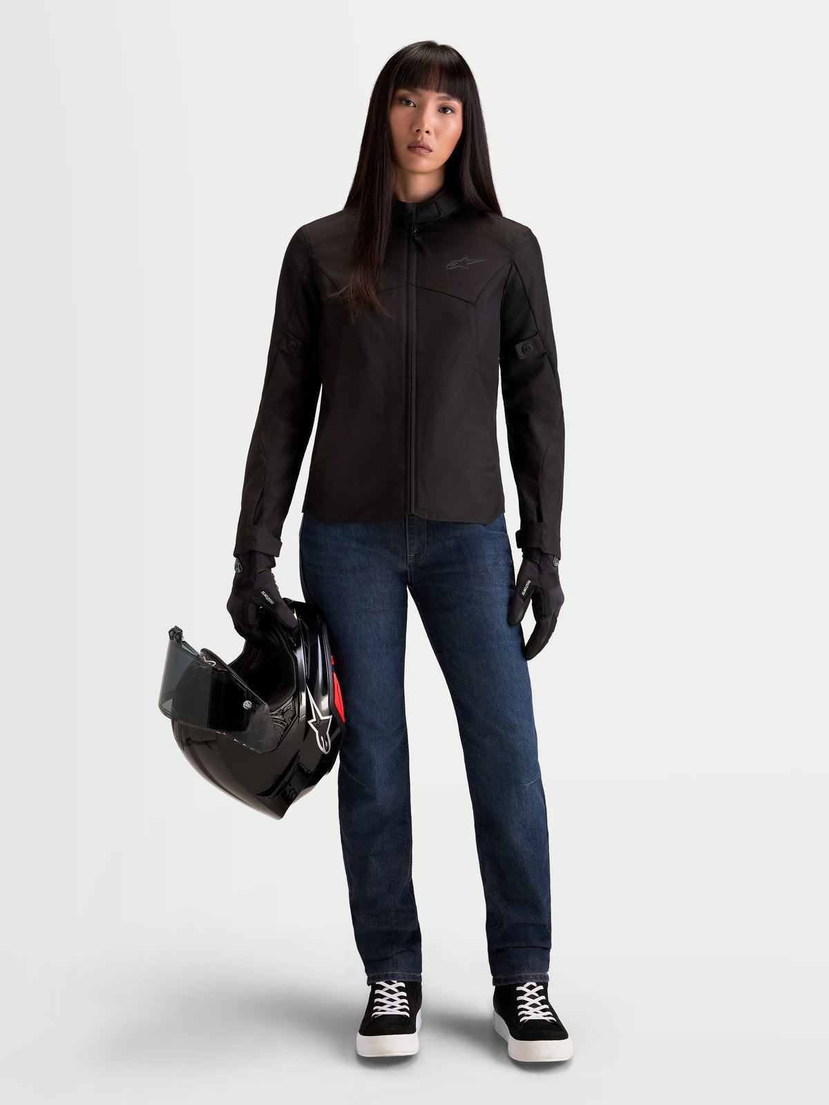 Alpinestars Stella Flex-AST 7 Denim Pants Short, women's urban motorcycle riding jeans in dark blue, worn by a model holding a black helmet and matching jacket, AA certified protection with stretch comfort