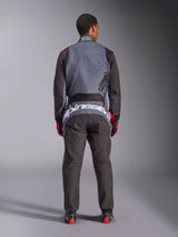 Alpinestars KMX-9 V3 Graphic 6 Suit, Karting Suit, Anthracite Black and Red, rear view showing large white Alpinestars branding across the lower back, gray upper body with black splatter graphics, black arms and legs, worn with red and black racing gloves and boots.