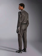 Alpinestars GP Race V3 Suit FIA, black auto racing suit with silver accents, worn by a model in a three-quarter rear view, paired with matching black racing gloves and boots, professional motorsport gear featuring a sleek two-layer design.