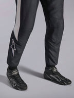 Alpinestars GP Pro Comp V2 FIA Suit, black and white auto racing gear with matched ASTARS professional racing boots.