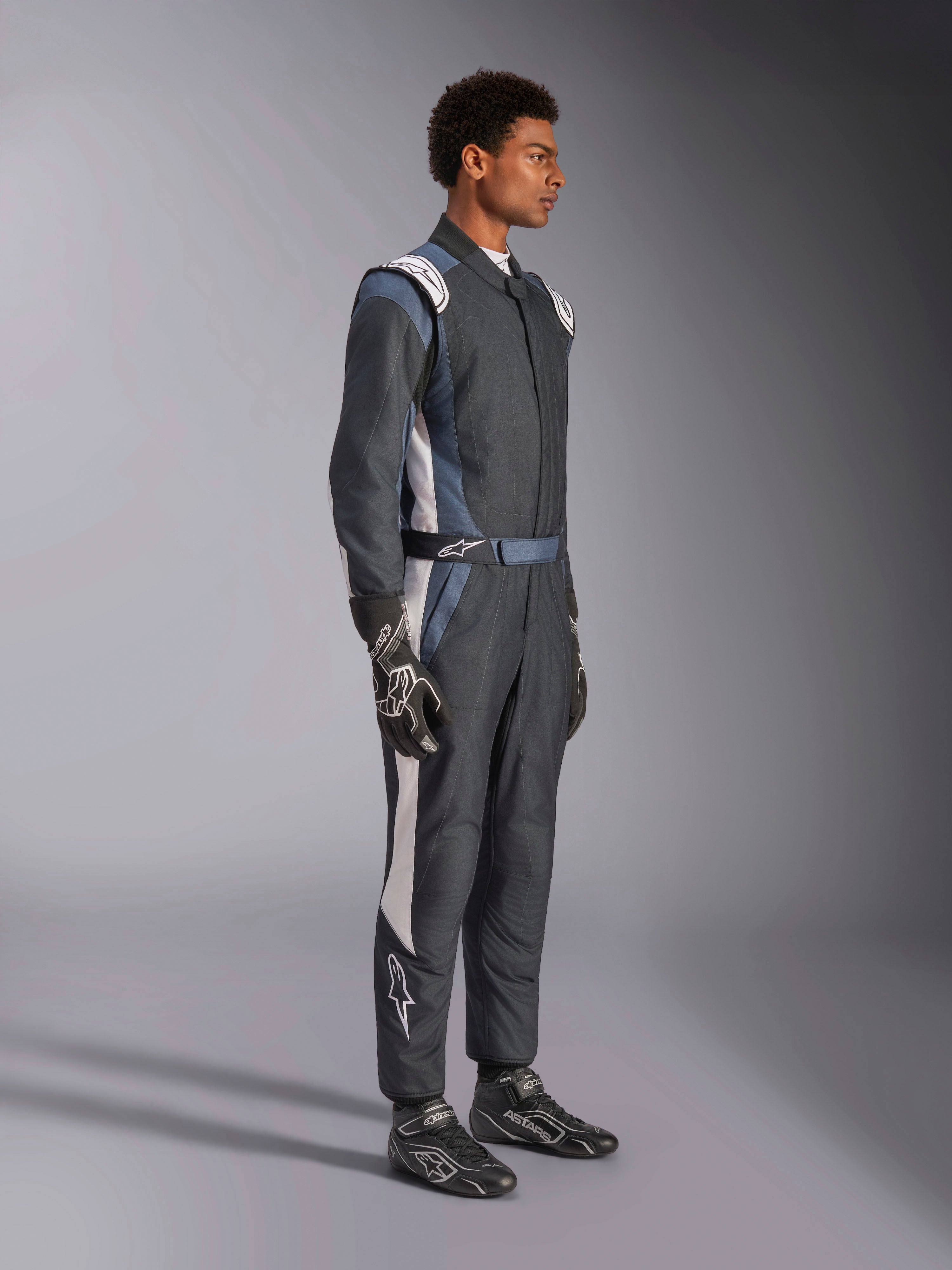 Alpinestars GP Pro Comp V2 FIA Suit, Men's Auto Racing Suit in Black, Asphalt, and White, side profile on model.