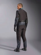 Alpinestars KMX-5 V3 Suit in Black Dark Shadow, rear view of model wearing full karting gear including matching gloves and racing shoes, featuring Alpinestars branding on the waist and dark shadow accents, professional karting gear.