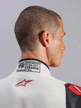 Alpinestars GP Tech V4 Suit, White Black Red auto racing suit, close-up of the back collar featuring the FIA 8856-2018 certification label and red star logo, professional motorsport safety gear