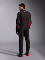Alpinestars KMX-9 V3 Suit, Black Red White, one-piece karting suit shown from the back, featuring white geometric stitching on the back and red accents on the sleeves, worn with black racing gloves and karting shoes.