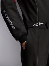 Alpinestars KMX-9 V3 Suit, Karting Suit, Black Red and White, close-up detail of the adjustable waist belt with star logo and sleeve with embroidered branding, featuring white contrast stitching and a side pocket.