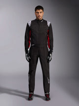 Alpinestars KMX-9 V3 Karting Suit in Black Red White, full-body front view of a model wearing the one-piece suit with coordinated racing gloves and shoes, featuring white Alpinestars logos on the shoulders and red accents.